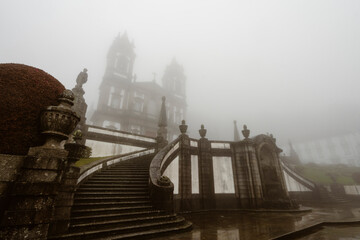 Fototapeta premium Foggy historic cathedral with a monumental stone staircase in Braga, Portugal