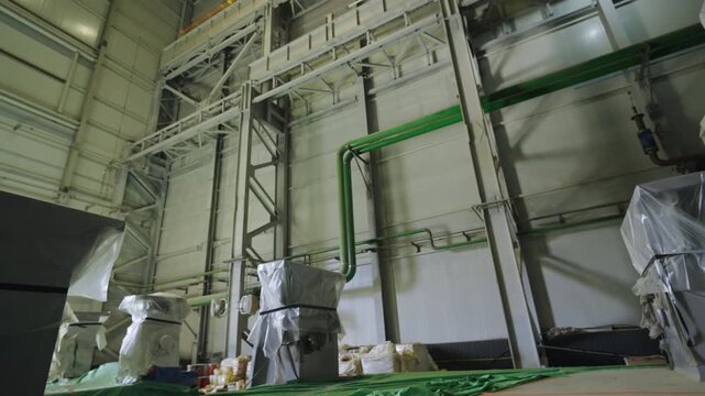 Massive industrial machinery covered with durable protective material. Technical power facility contains substantial industrial units