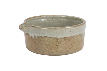 Rustic handmade ceramic bowl with a pouring spout and two-tone glaze, isolated on a clean white...