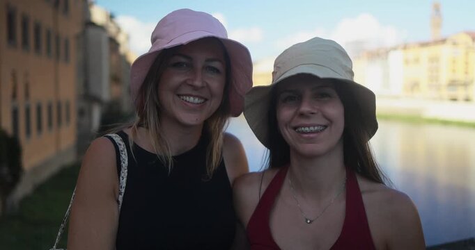 Happy women friends having fun smiling on camera during Italian city trip - Vacation, young people and travel concept - UGC content