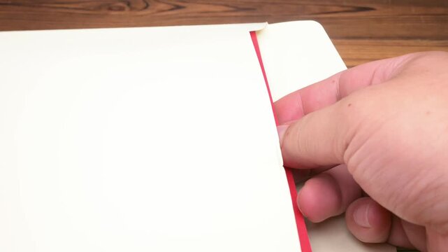 Man opens a 3D pop-up greeting card with delicate Chinese paper-cut style sheep pattern for the year of the goat the Chinese word means fortune