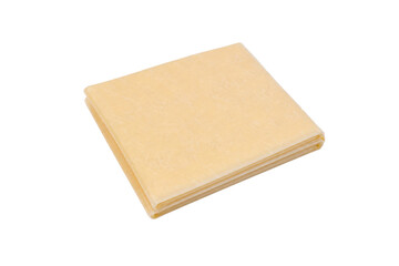 Stack of thin, square, light yellow pasta sheets is neatly folded, presented on a clean white background © Chinases