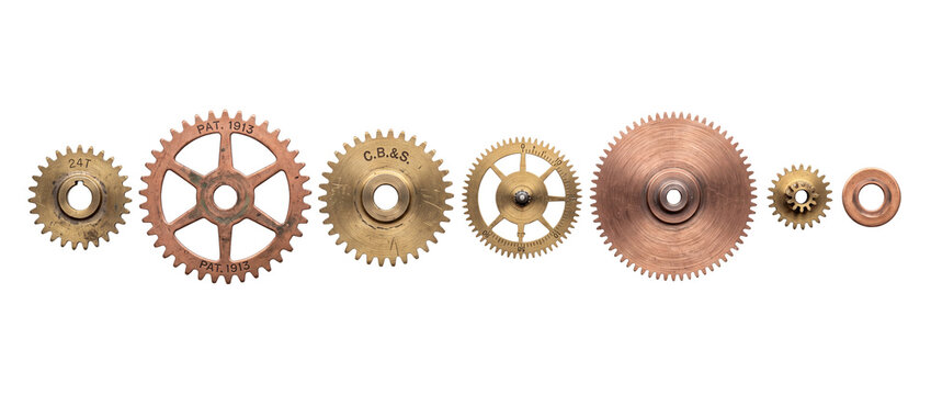 Vintage brass gears metal cogs mechanical clockwork set arranged in horizontal row on black background, highlighting antique copper mechanism parts, industrial engineering, steampunk technology.