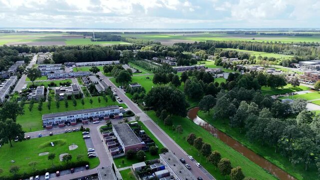Drone footage of Nagele, a unique 1950s modernist Dutch village designed by Rietveld, featuring minimalist architecture and geometric polder layouts.