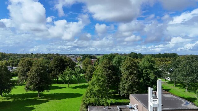 Drone footage of Nagele, a unique 1950s modernist Dutch village designed by Rietveld, featuring minimalist architecture and geometric polder layouts.