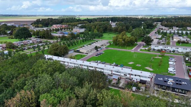 Drone footage of Nagele, a unique 1950s modernist Dutch village designed by Rietveld, featuring minimalist architecture and geometric polder layouts.