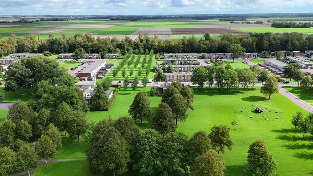 Drone footage of Nagele, a unique 1950s modernist Dutch village designed by Rietveld, featuring minimalist architecture and geometric polder layouts.