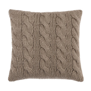 Cozy light brown knitted square pillow with intricate cable knit patterns is presented on a clean white background