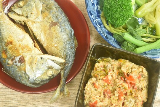 batter fried mackerel with boiled vegetable on red plate dipping spicy fish meat paste sauce cup