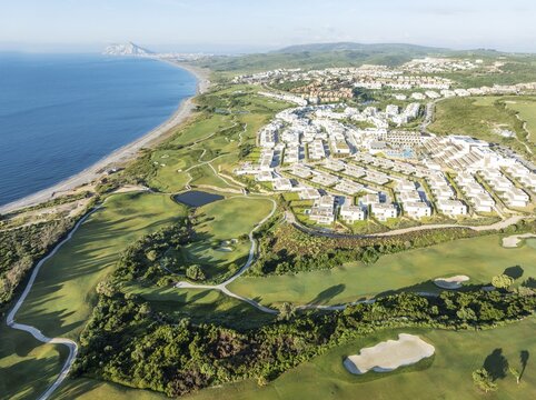 The La Hacienda Links Golf Resort at the Mediterranean Sea with the Rock of Gibraltar (British) in the distance. Prominent the Fairmont La Hacienda hotel. Aerial view. Drone shot. C&aacute;diz province, Andalusia, Spain