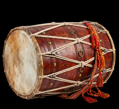 Traditional wooden dhol drum with rope tension and red tassels on transparent background