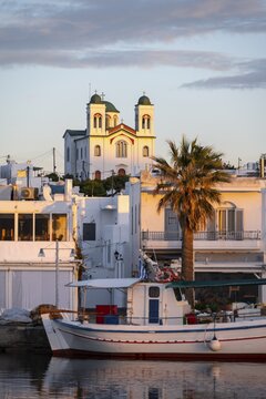 Evening atmosphere, city view, harbour with fishing boat and church, harbour town Naoussa, Paros Island, Cyclades, Greece