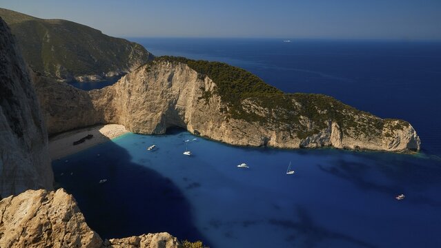 Paralia Navagio, Shipwreck Beach, rocky cliff, shipwreck MV Panagiotis, excursion boats, blue and turquoise crystal clear sea, cloudless blue sky, Zakynthos, Ionian Islands, Greece