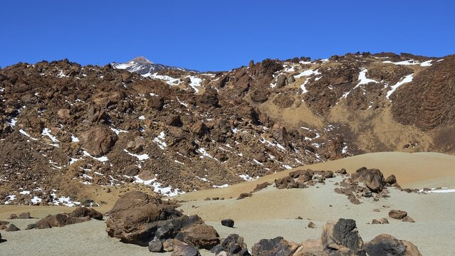 Rocky landscape covered by snow under a clear blue sky with the volcano Teide, Teide, Parque Nacional del Teide, Teide National Park, volcano, volcanism, UNESCO World Heritage Site, Tenerife, Canary Islands, Spain