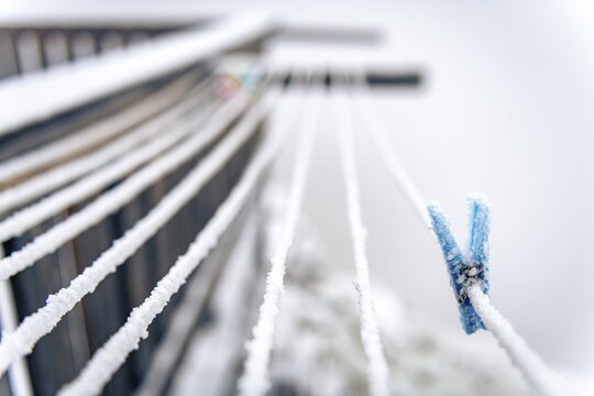 Iced clothespin on rope, mountain peak rising from clouds, S&ouml;lden, &Ouml;tztal, Tyrol, Austria