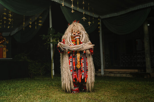 Balinese Rangda mask dance performance, traditional Indonesian ritual folklore costume, mysterious demon spirit culture, night outdoor ceremony