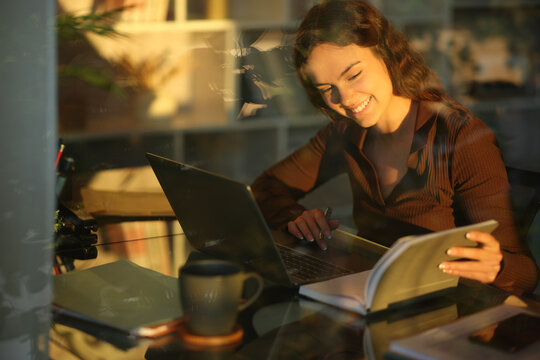 Happy telecommuter checking paper agenda at work