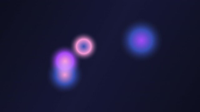 Abstract glowing blurred light orbs on dark background