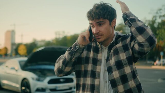 Stressed Caucasian man driver calling auto assistance service beside broken car open bonnet after accident upset sad male businessman talking mobile phone need tow truck emergency repair help outdoors
