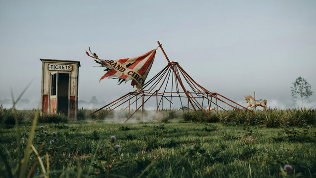 Old wooden ticket booth standing next to a broken circus tent frame in a foggy field with a vintage rocking horse toy on the green grassy ground