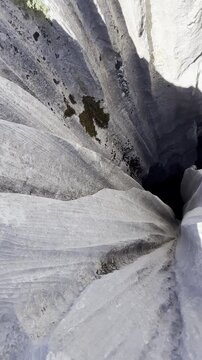 Adventurer Walking Above Dangerous Sinkholes in a Rugged Mountain Landscape