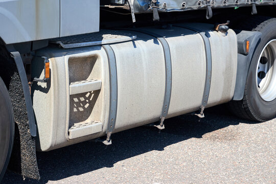 Truck fuel tank close up with footsteps on semi trailer vehicle side on road transport logistics freight heavy cargo metal diesel container vehicle industrial highway commercial trucking