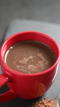 Warm cup of hot chocolate served on a table in a cozy indoor setting, ideal for winter, Christmas, holiday and comfort drink concepts.