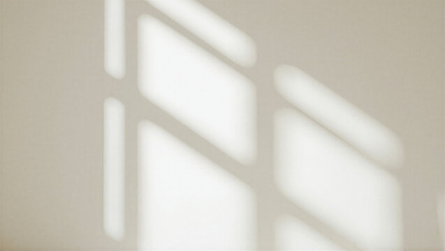 Abstract sunlight casting geometric window frame shadows on a beige wall