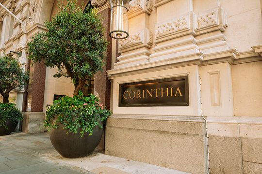 London, England, United Kingdom, August 14, 2026. Entrance sign and potted plants at Corinthia Hotel London building.