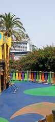Colourful park with trees in foreground of cruise ship, Cadiz, Spain. © Michael