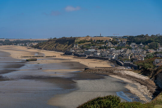 Arromanches-les-Bains, France - 08 10 2026:  Normandy landing blockhouse. Panoramic view of the artificial port with pontoons bridges, the beach, the sea, cliffs and the city from coastal path