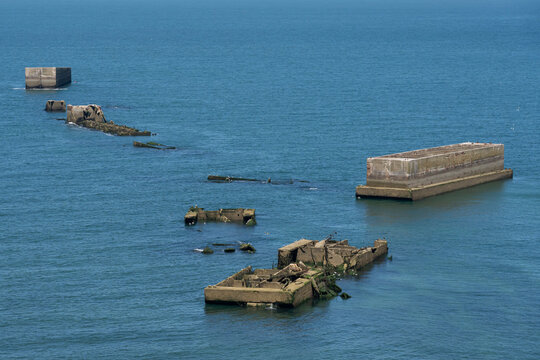 Arromanches-les-Bains, France - 08 10 2026:  Normandy landing blockhouse. Detail view of the artificial port and pontoons bridges in the middle of the sea