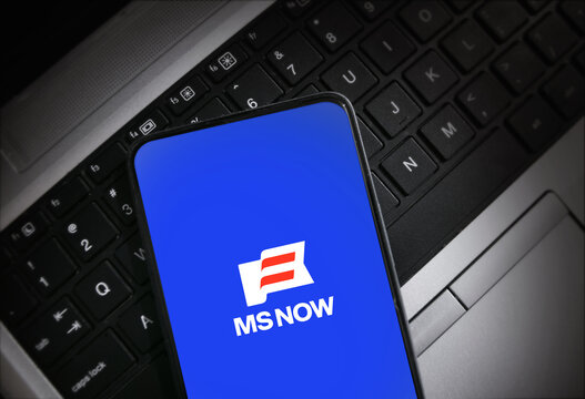 Ms now app on smartphone screen on laptop keyboard illustrative editorial