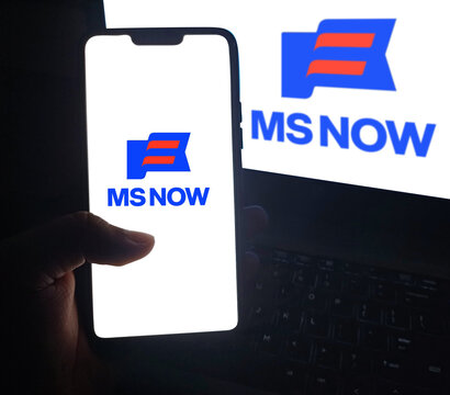 Ms Now news app logo on mobile phone screen illustrative editorial with laptop keyboard background