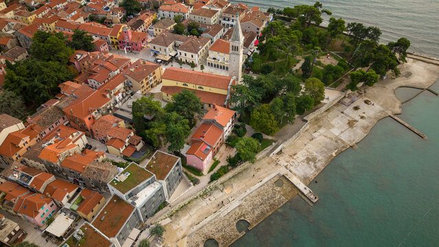 Aerial view of St Pelagius church bell tower and coastal promenade in Novigrad Istria Croatia