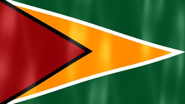 National Flag Of Guyana Displaying Golden Arrowhead Design On Green Background Waving.