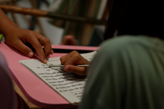 Mother Supporting Daughter Education and Homework at Wooden Table