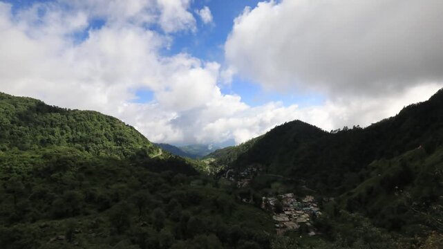A dramatic monsoon timelapse capturing fast-moving storm clouds rolling over the lush green hills of Narayan Nagar and Char Khet.
