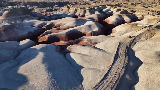 Drone View of ATV Vehicle Moving on Road on Hills in Desert Landscape of Utah USA