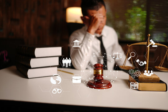 Stressed Lawyer Touching Head with Legal Technology Icons, Gavel and Scales of Justice