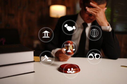 Stressed Lawyer Covering Face with Legal Technology Icons 