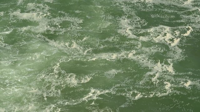 Top Down View of Swirling Sea Water and Foamy Ocean Surface