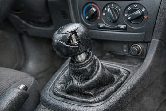 A detailed shot of a car's gear shift lever, great for automotive or transportation-related uses