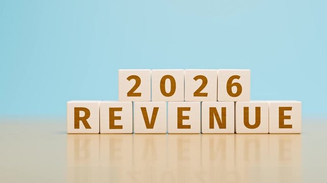 Wooden toy cubes forming the text "2026 REVENUE". Concept for revenue, earnings, income, profit reached or planned for the year 2026 of an organisation or company. Dolly Camera