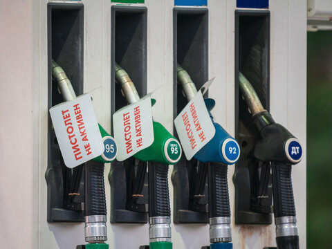Fuel pumps under repair at gas station in Russia. Out of order signs on nozzles with Russian text translated as Pistol is not active. Concept of fuel shortage, energy crisis or economic problems