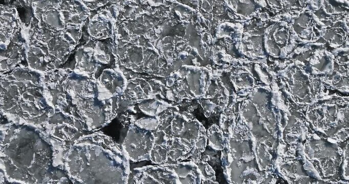 Top down view of frozen floes in winter on river.