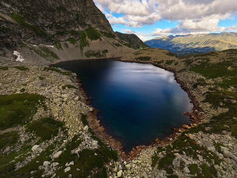 Aerial View of Alpine Lake Surrounded by Rocky Mountains