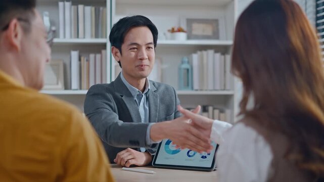 real estate agent and client shaking hands for a successful home insurance deal or property mortgage. Concept of house buying, financial agreement, and investment security at office
