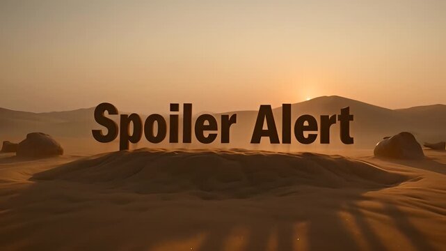 Spoiler alert text emerging from desert sand dunes at sunset