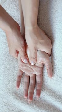 Therapist smooths oil along a womans forearm with both hands at a spa. Arm massage and skin care for spa, wellness and beauty relaxation marketing